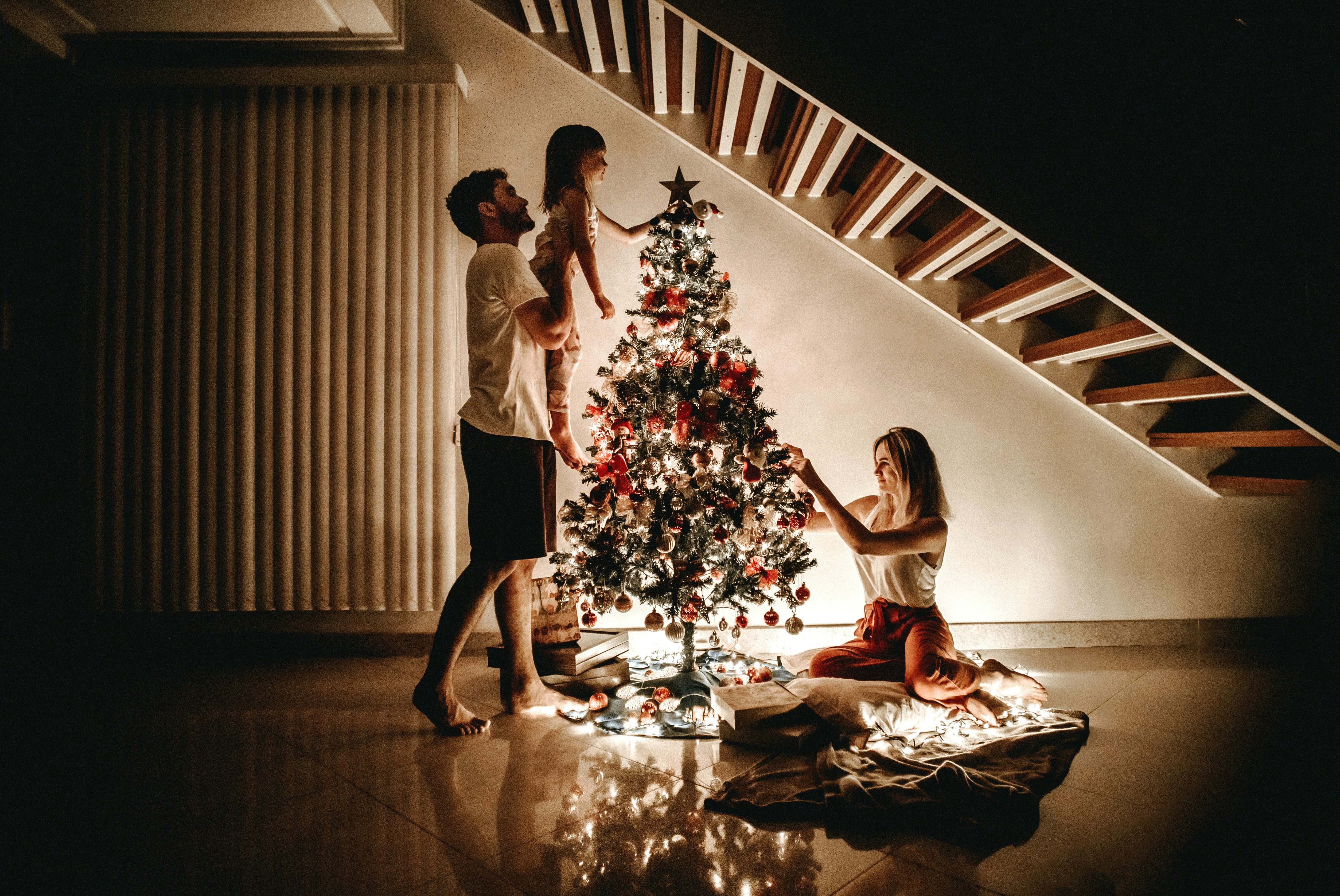 Family decorating a Christmas Tree